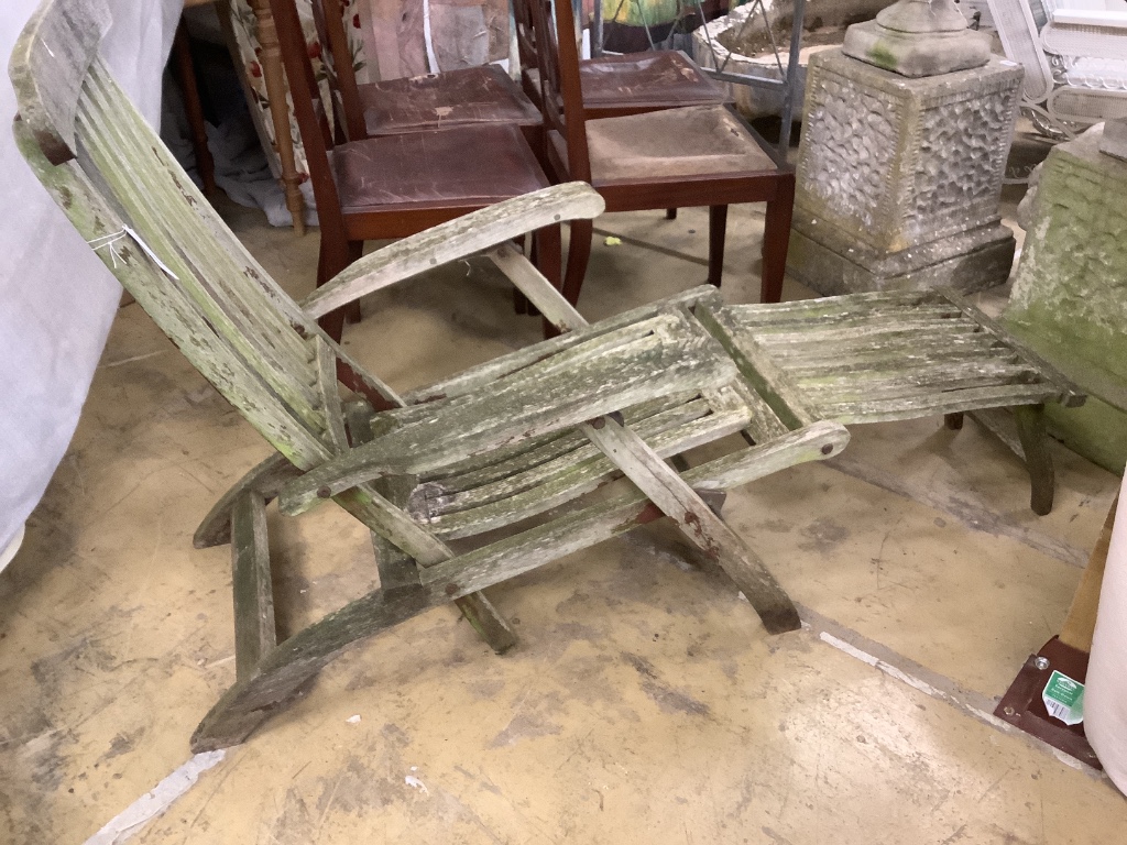 A weathered teak folding garden steamer chair